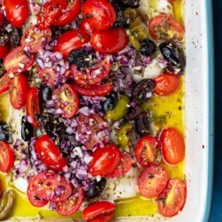 White fish topped with tomatoes and olives