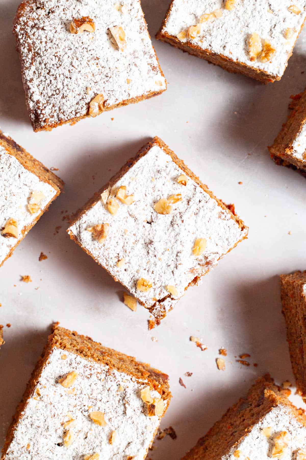 An and overhead photo of 8 slices of healthy carrot cake.