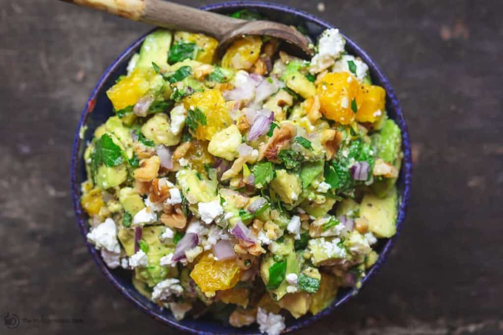 Citrus Avocado Dip in Serving Bowl with a small wooden spoon