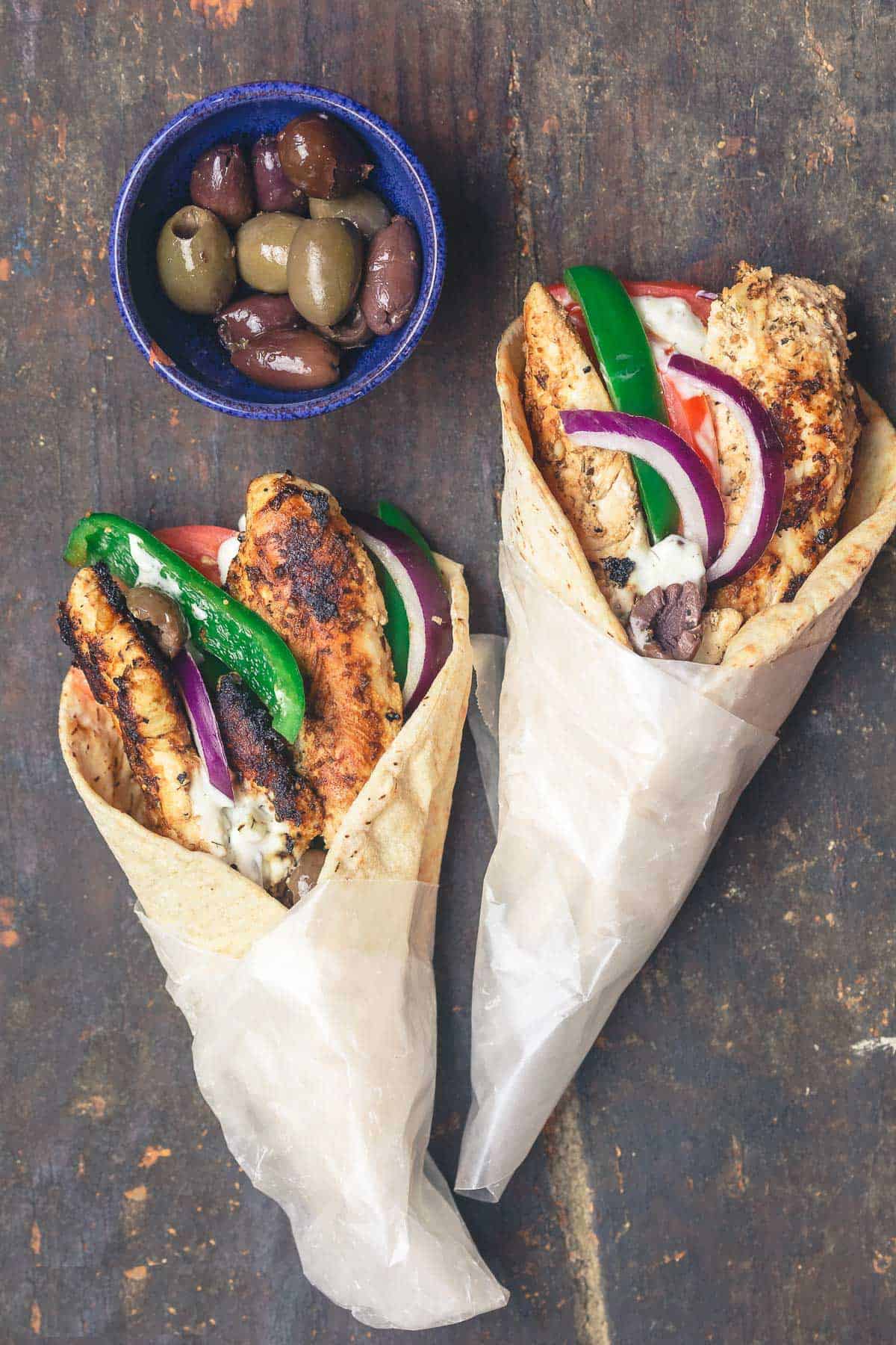 Chicken gyro wraps served with black and green olives.