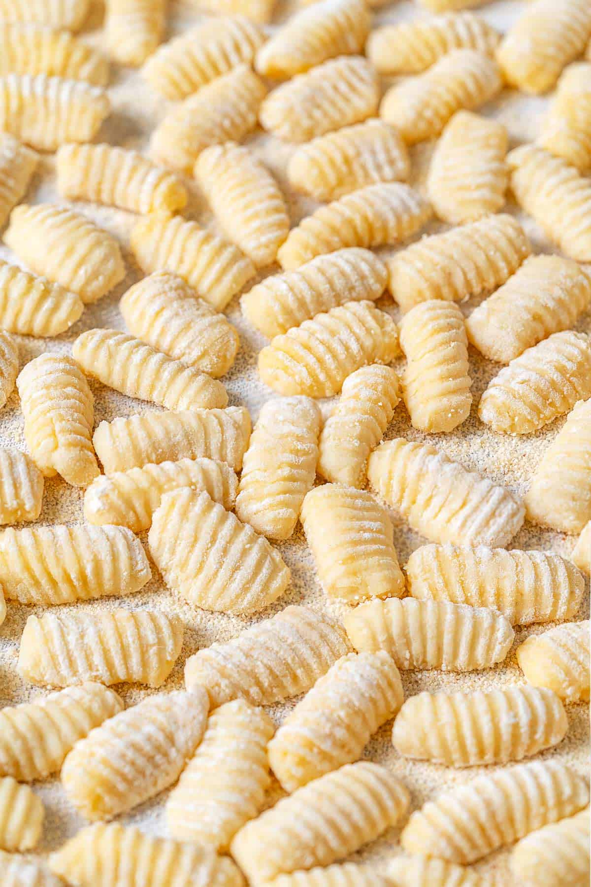 Potato gnocchi that have been dusted with semolina flour to prevent sticking.