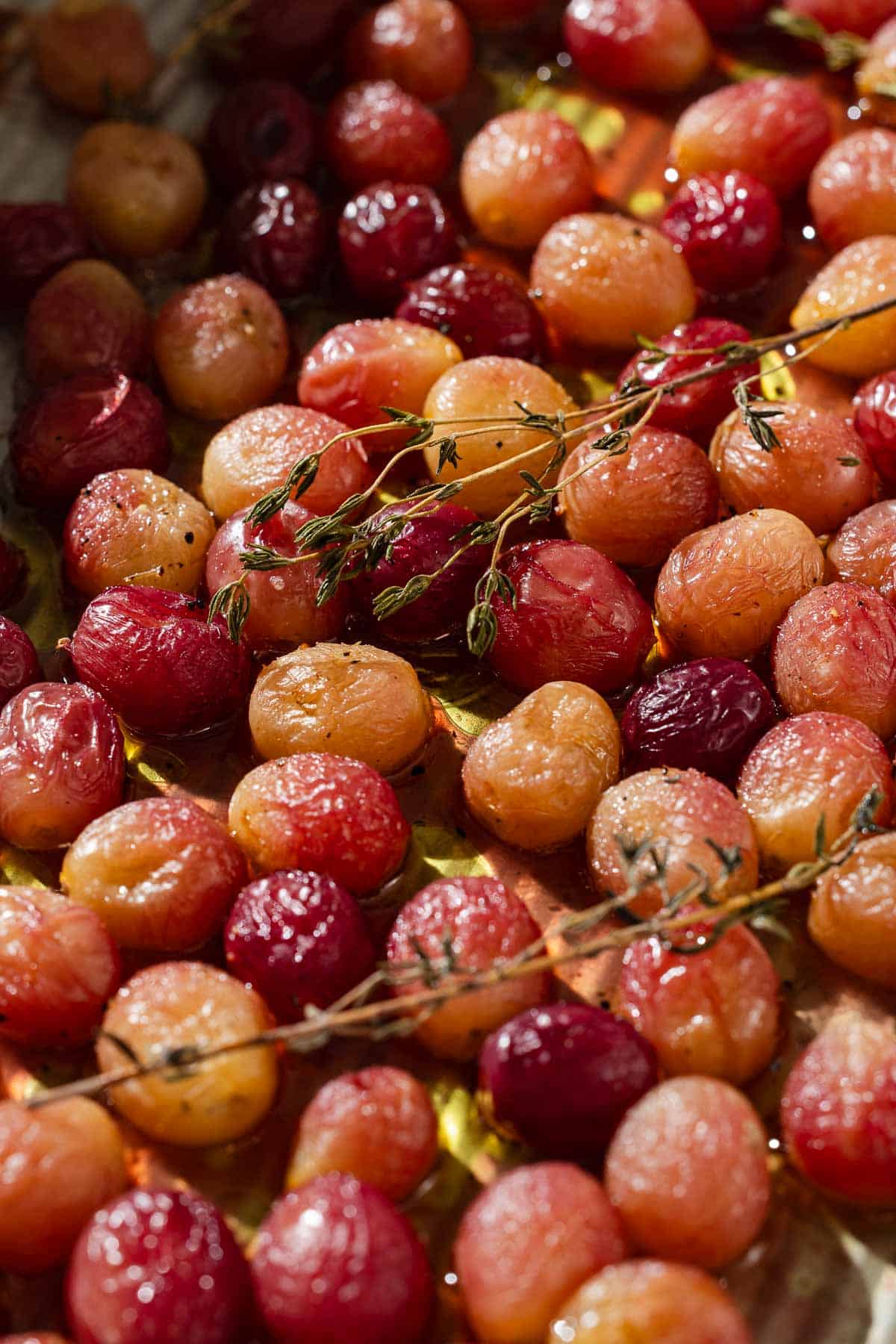 A close up of roasted grapes with sherry and thyme.