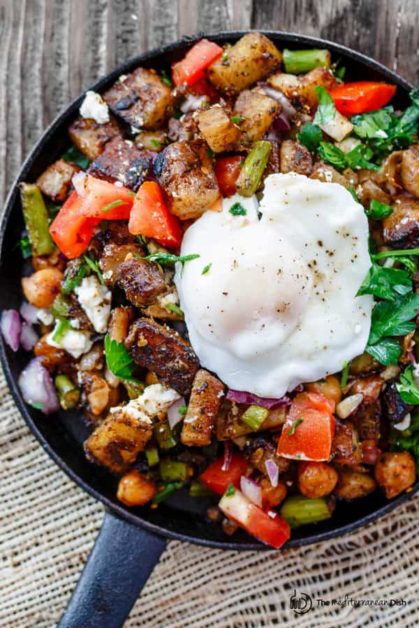 Mediterranean Potato Hash Recipe | The Mediterranean Dish. An easy breakfast hash with potatoes, chickpeas, asparagus, tomatoes and Mediterranean spices and fresh herbs. Comes together in less than 30 mins. See the step-by-step today on The Mediterranean Dish.