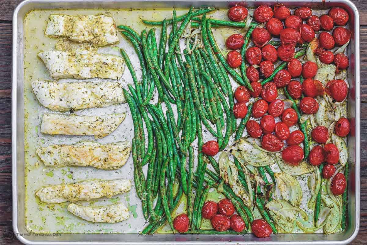 Halibut ingredients on a tray spiced and ready to enter into oven