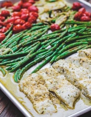 One Pan Baked Halibut Recipe | The Mediterranean Dish. Halibut fillet with green beans and cherry tomatoes baked in a delicious Mediterranean sauce with garlic, olive oil and lemon juice. Comes together in less than 30 mins! See the step-by-step on The Mediterranean Dish.