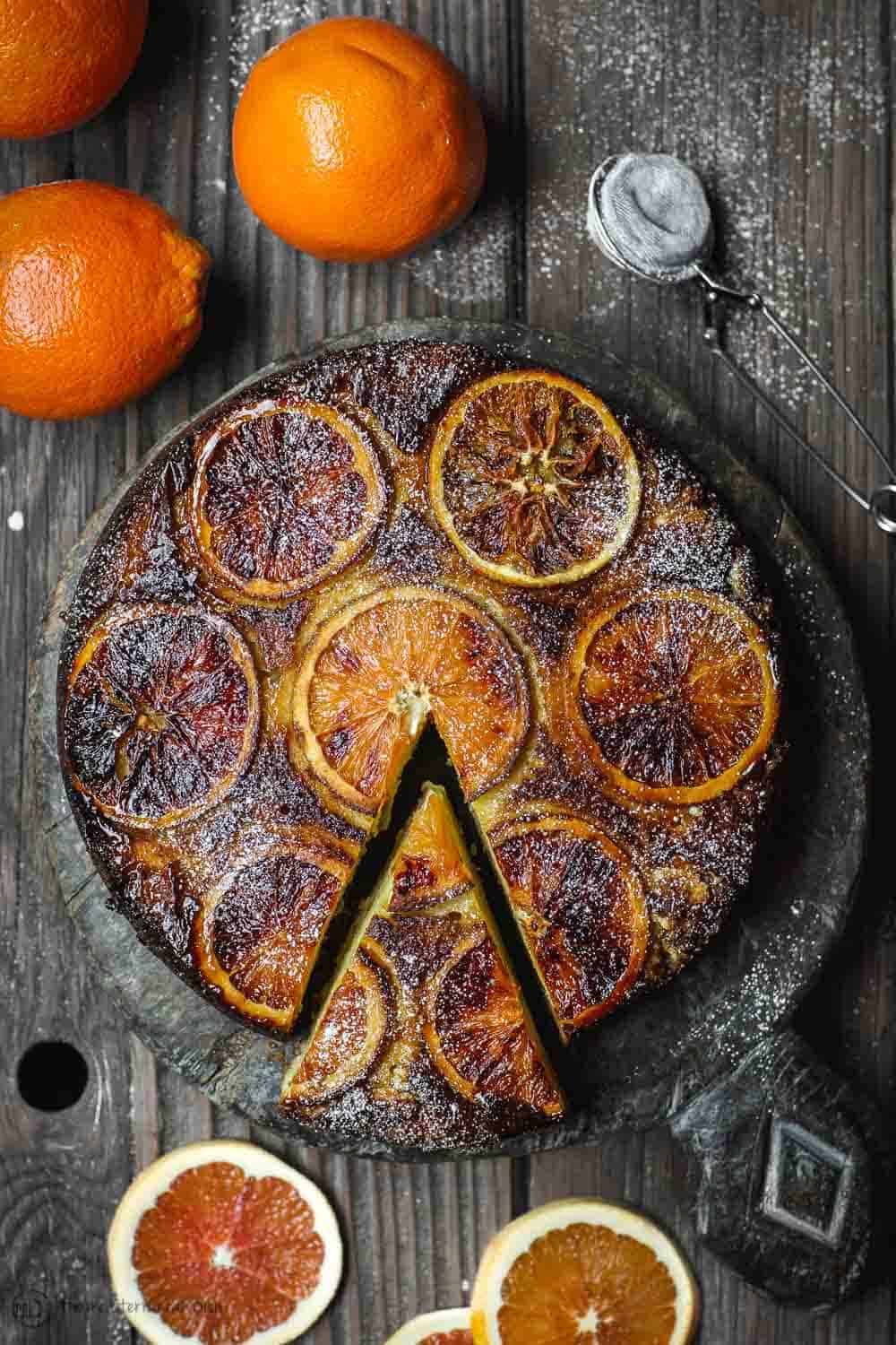 Orange Cake On Serving Plate. One slice being pulled out.