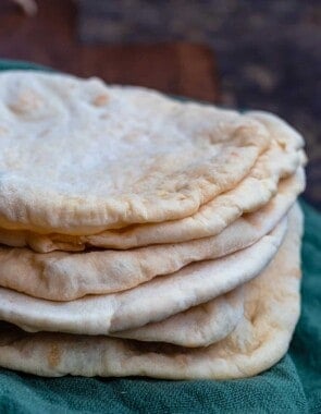 Stack of pita bread over a kitchen towel