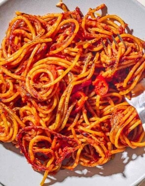 An overhead photo of a serving spaghetti all'assassina on a plate with a fork.