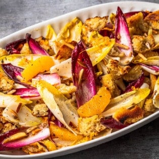 a close up of endive salad in a serving bowl.