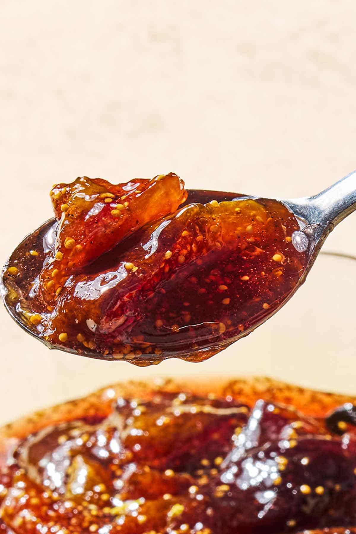 A close up of fig jam on a spoon.