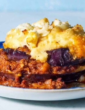 A close up of a serving of Greek Shepherd's Pie on a plate.