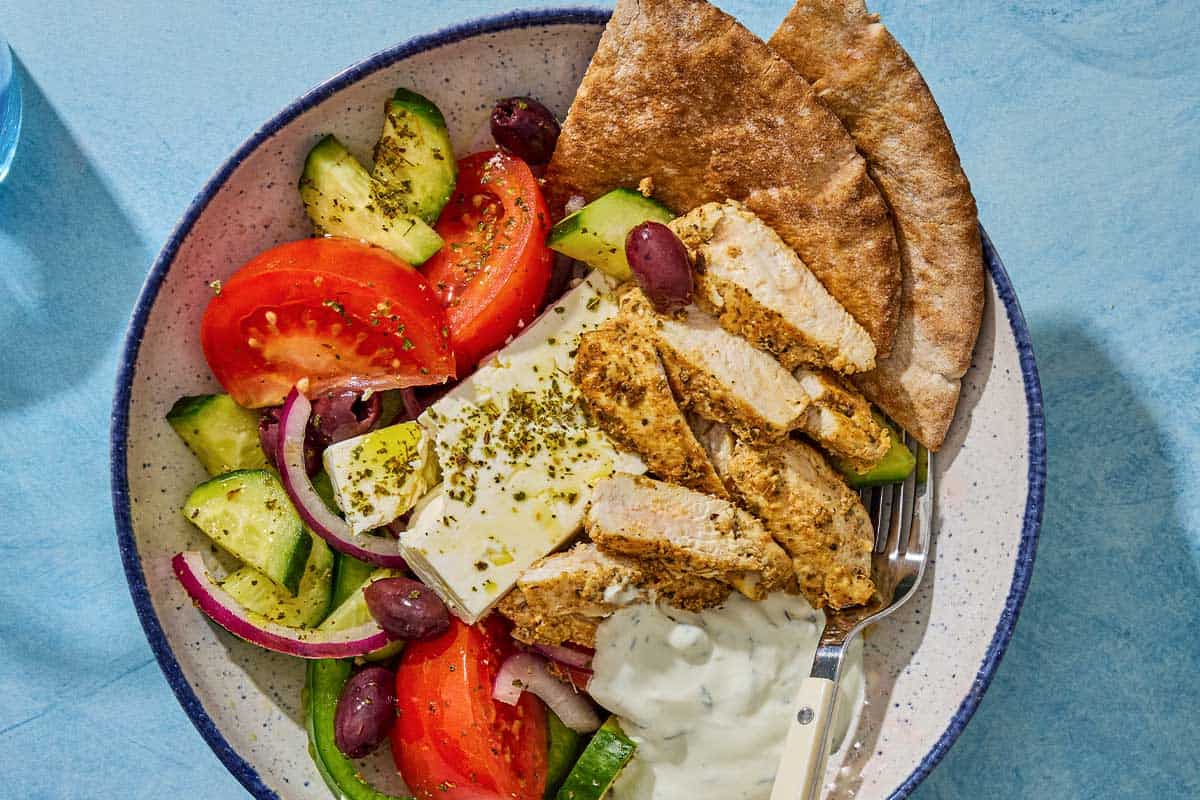 An overhead photo of a gyro bowl with a fork.