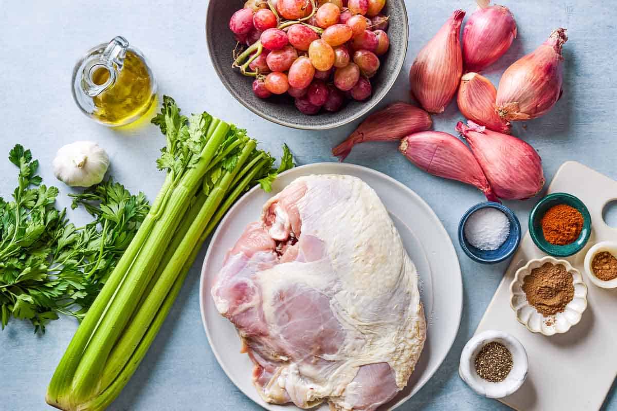 Ingredients for roast turkey breast including bone in turkey breast, salt, allspice, paprika, black pepper, nutmeg, garlic, parsley, olive oil, shallots, celery, and red grapes.