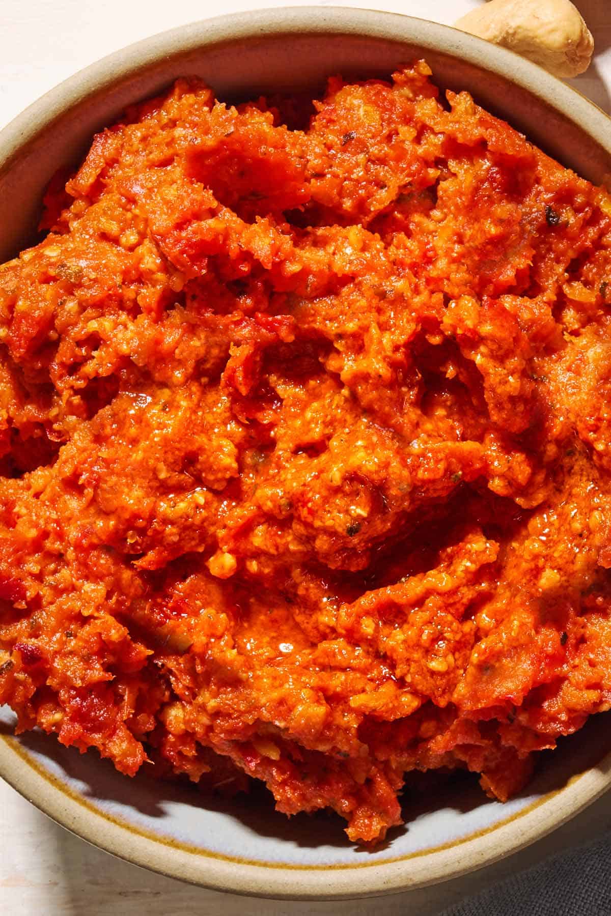 An overhead close up photo of sun dried tomato pesto in a bowl.