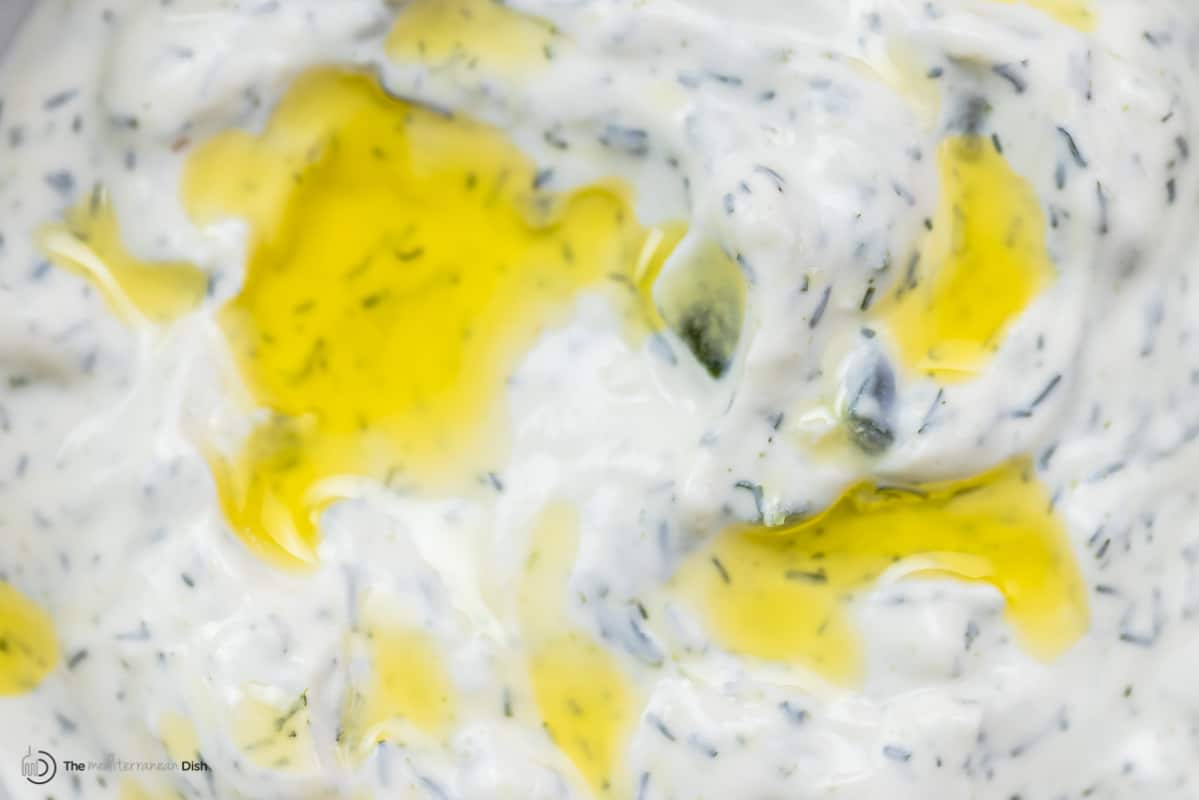 Close-up of Greek tzatziki sauce with a drizzle of olive oil on top